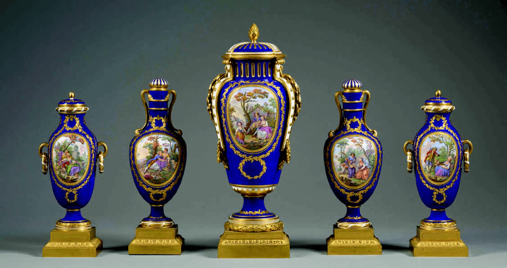 Garniture composée d’un vase «à bandes », de deux vases «bouteille» et de deux vases « Pongon », 1773, porcelaine tendre. Socle en bronze